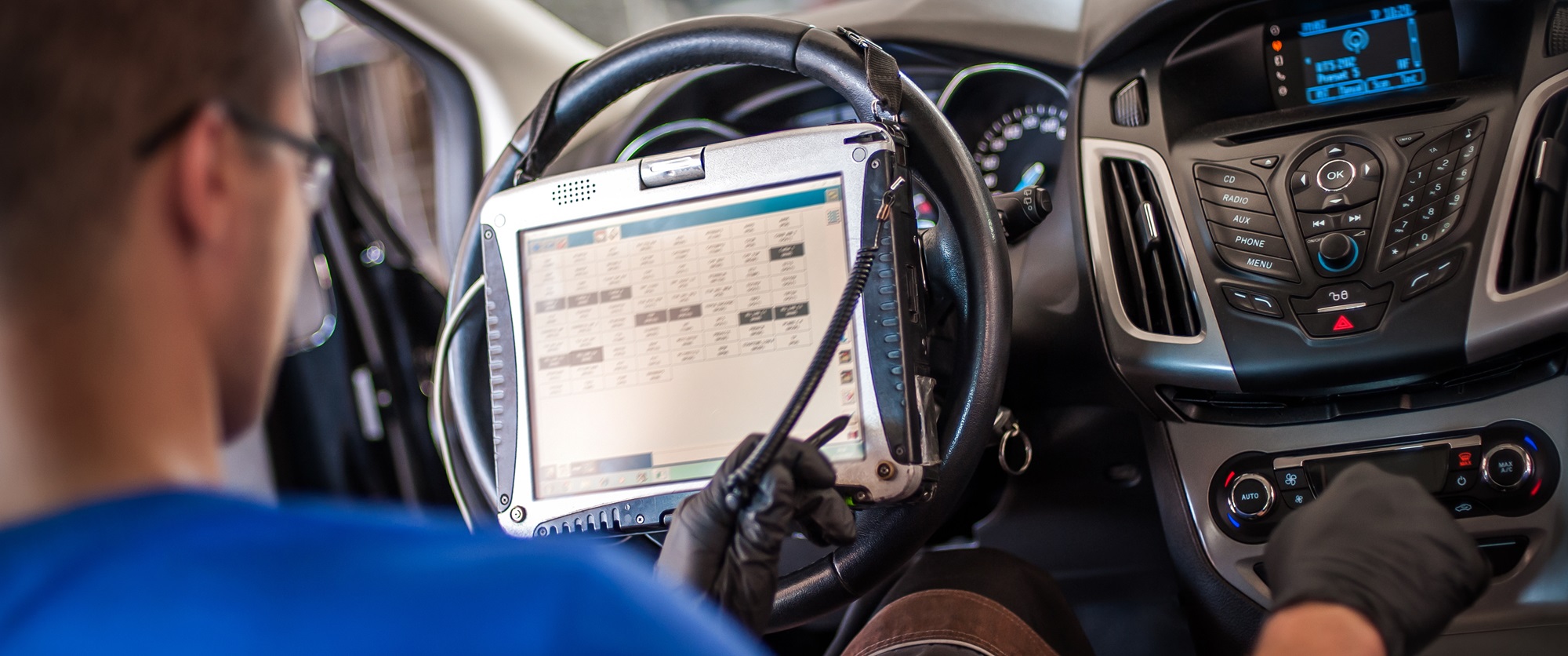 Automobile computer diagnosis. Car mechanic repairer looks for engine failure